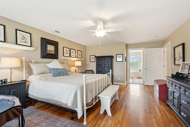 bedroom with wood finished floors, visible vents, a ceiling fan, and baseboards