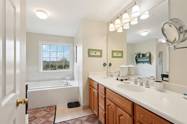 full bathroom with double vanity, tile patterned flooring, tiled bath, and a sink