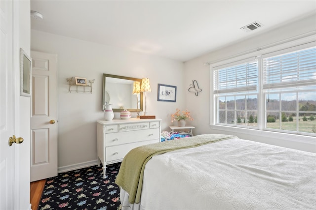 bedroom with baseboards and visible vents