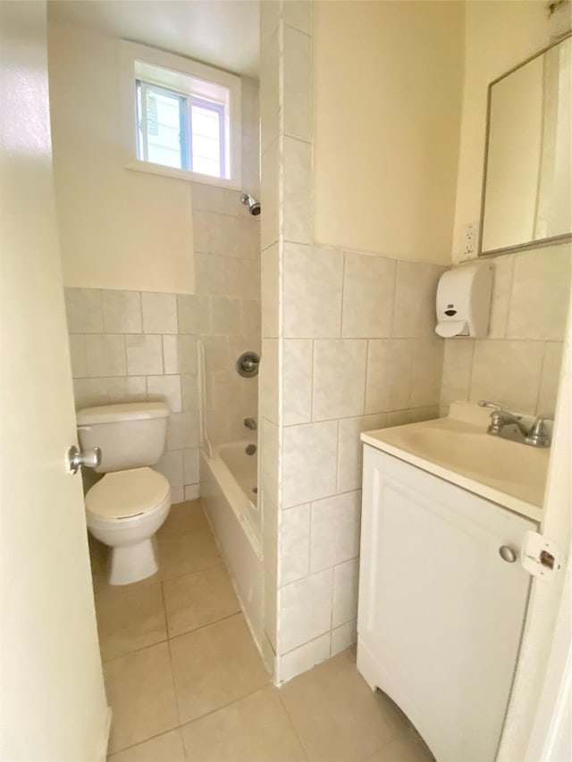 bathroom featuring tub / shower combination, vanity, tile patterned flooring, toilet, and tile walls