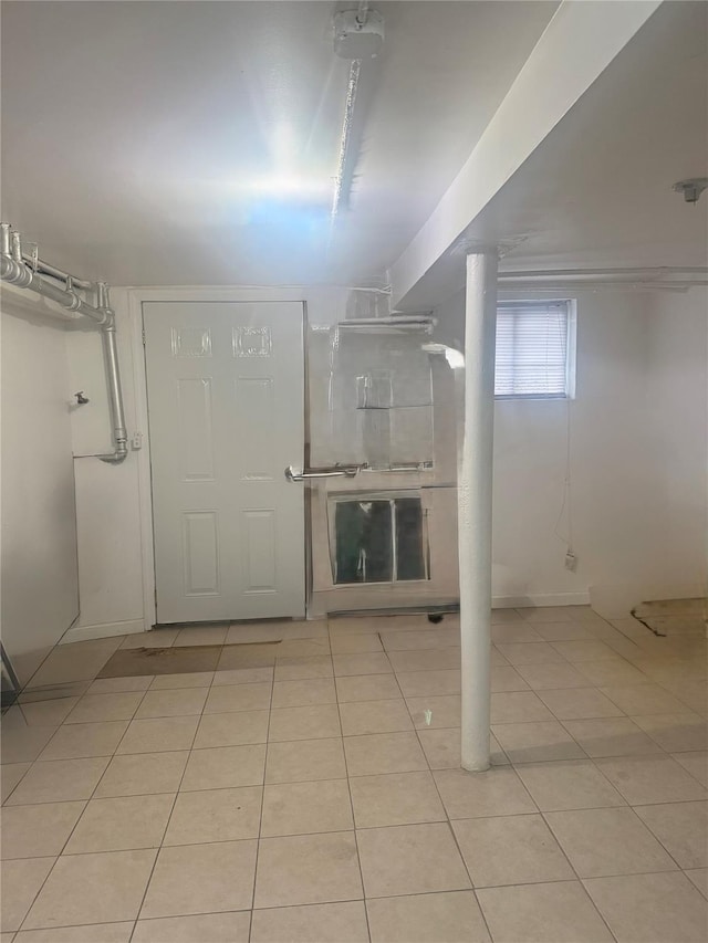 basement featuring light tile patterned floors