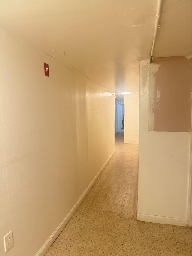 hallway featuring baseboards