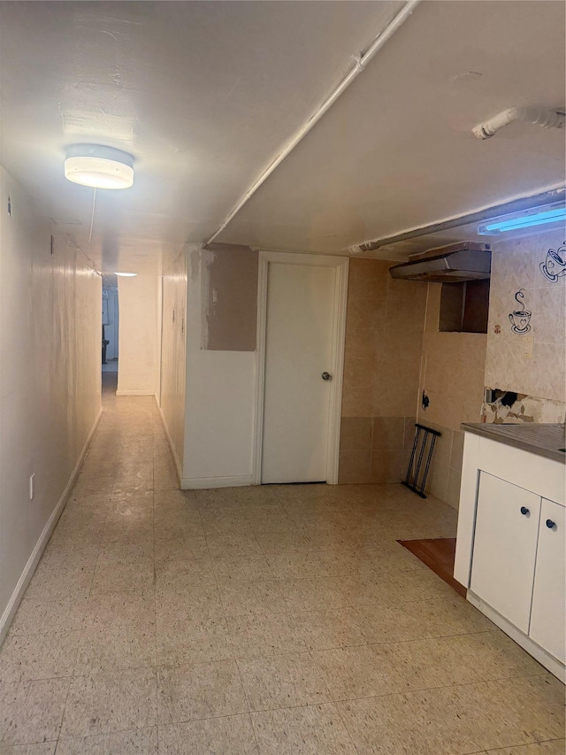 finished below grade area featuring light floors