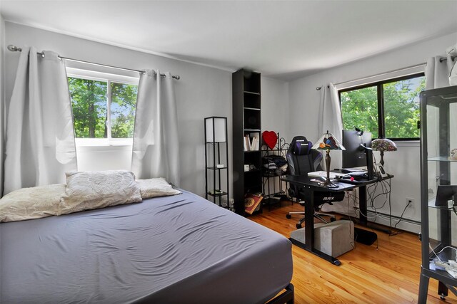 2358 Maple Ave, Cortlandt Manor, NY 10567 - bedroom with wood finished floors, a desk, and a baseboard heating unit