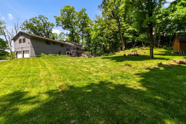 2358 Maple Ave, Cortlandt Manor, NY 10567 - view of grassy yard featuring stairway, a wooden deck, a detached garage, and a storage shed