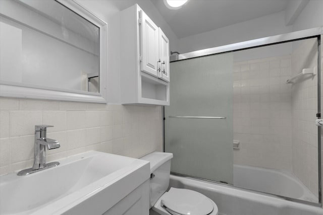35-20 Leverich St Unit A 504, Jackson Heights, NY 11372 - bathroom with backsplash, vanity, toilet, and enclosed tub / shower combo