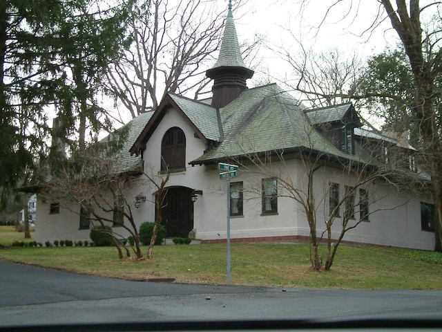 view of front of home featuring a front lawn and stucco siding