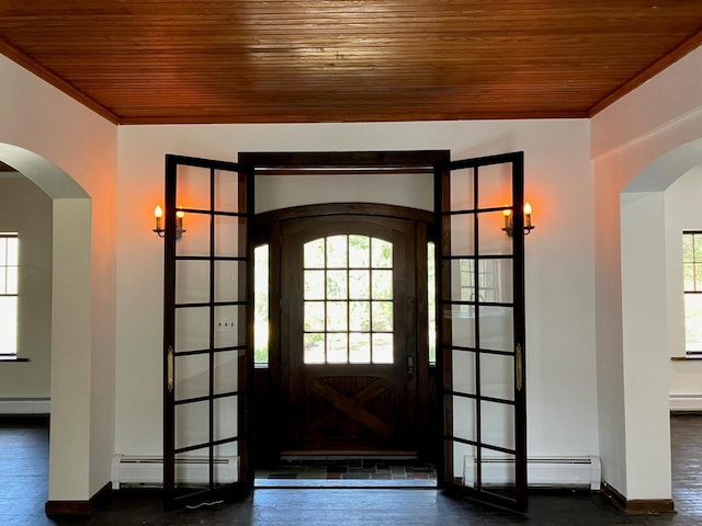 foyer featuring arched walkways, wooden ceiling, and a baseboard heating unit