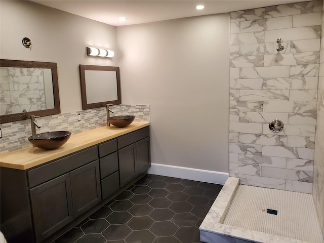 full bath with a sink, tasteful backsplash, and recessed lighting