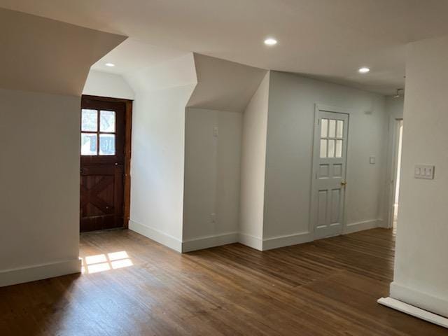 bonus room featuring wood finished floors, baseboards, and lofted ceiling