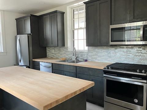 kitchen with butcher block counters, plenty of natural light, a sink, and appliances with stainless steel finishes