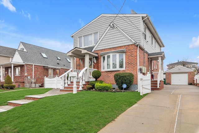 view of front of house with a detached garage, driveway, a front lawn, brick siding, and an outbuilding