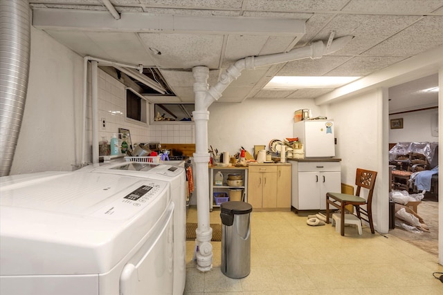 interior space with washing machine and clothes dryer and light floors
