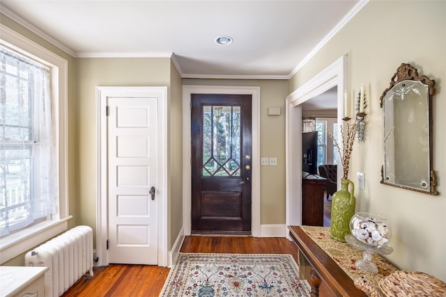 3 Druid Hill Rd, Port Jefferson, NY 11777 - foyer entrance with radiator, wood finished floors, crown molding, and baseboards