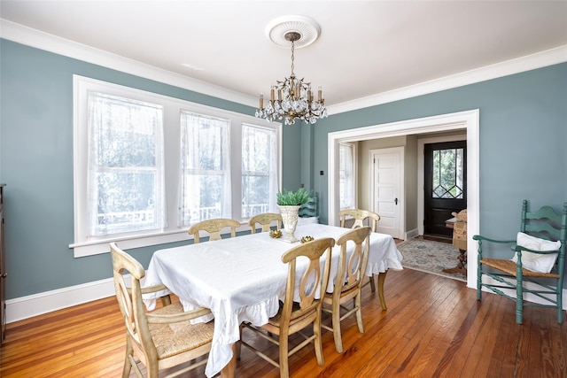 3 Druid Hill Rd, Port Jefferson, NY 11777 - dining space with a chandelier, crown molding, wood-type flooring, and baseboards