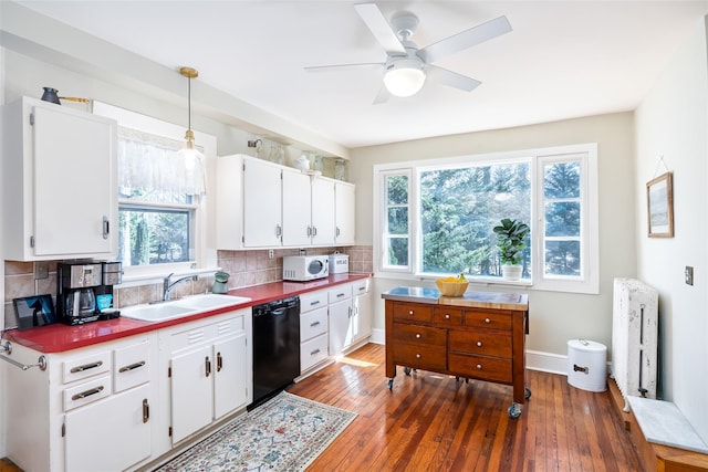 3 Druid Hill Rd, Port Jefferson, NY 11777 - kitchen featuring dishwasher, white microwave, a sink, and hardwood / wood-style flooring