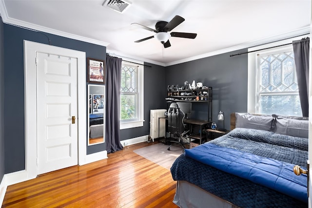 3 Druid Hill Rd, Port Jefferson, NY 11777 - bedroom with radiator, wood finished floors, crown molding, baseboards, and a desk