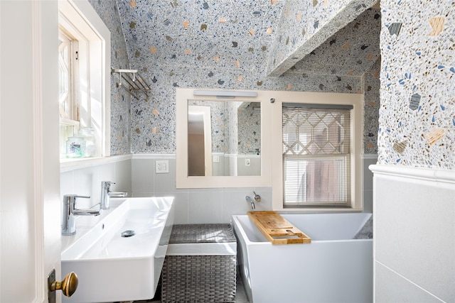 3 Druid Hill Rd, Port Jefferson, NY 11777 - bathroom with a sink, a tub to relax in, plenty of natural light, tile walls, and wainscoting