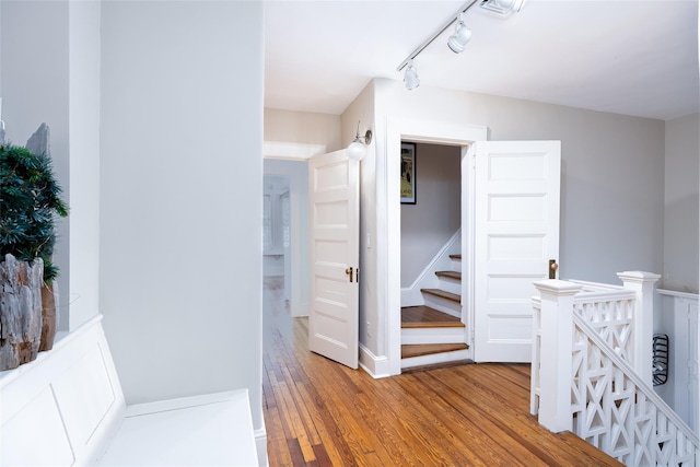 3 Druid Hill Rd, Port Jefferson, NY 11777 - corridor with wood finished floors, track lighting, and an upstairs landing