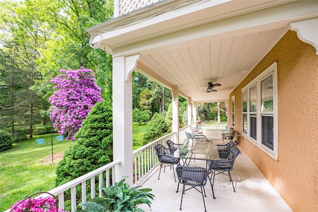 3 Druid Hill Rd, Port Jefferson, NY 11777 - wooden porch featuring a ceiling fan, a yard, and outdoor dining space