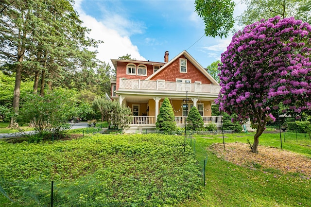 3 Druid Hill Rd, Port Jefferson, NY 11777 - view of front of home featuring a balcony, covered porch, a front lawn, and a chimney