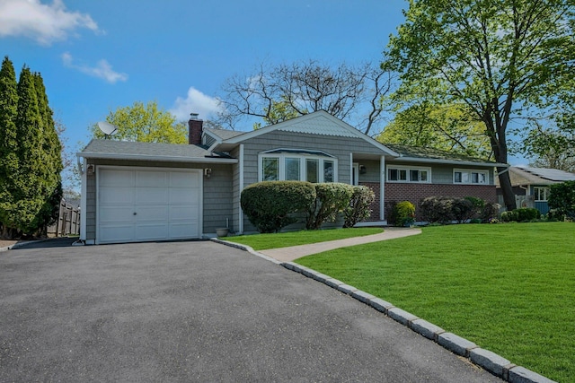 single story home with an attached garage, a front lawn, aphalt driveway, and a chimney