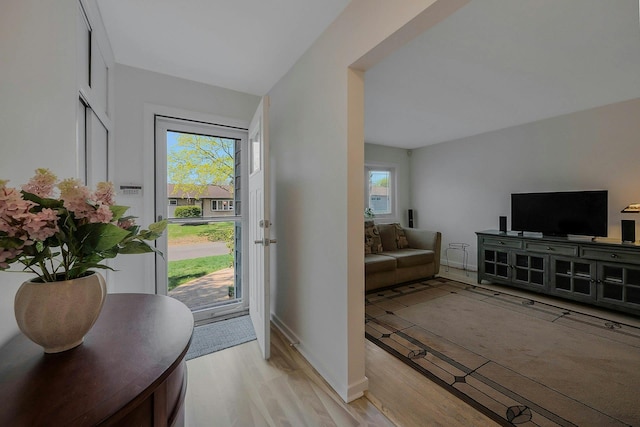 entrance foyer featuring baseboards and light wood finished floors