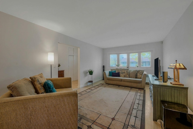 living area featuring baseboards