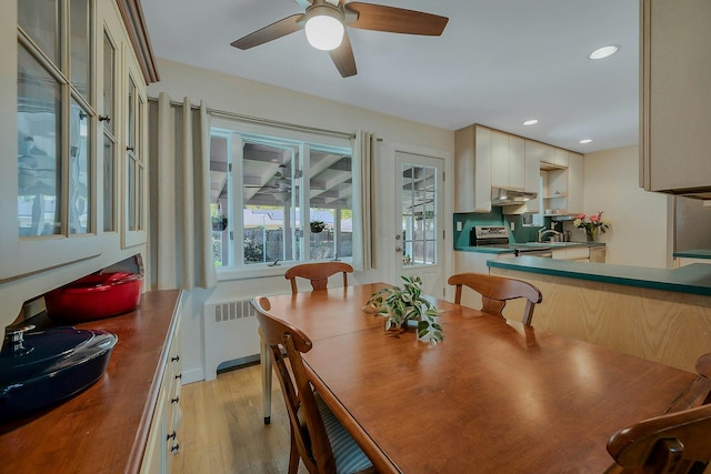 dining space with light wood-type flooring, a ceiling fan, radiator, and recessed lighting