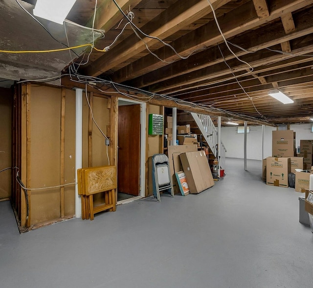 unfinished basement featuring stairs