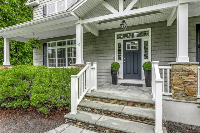 view of exterior entry featuring a porch