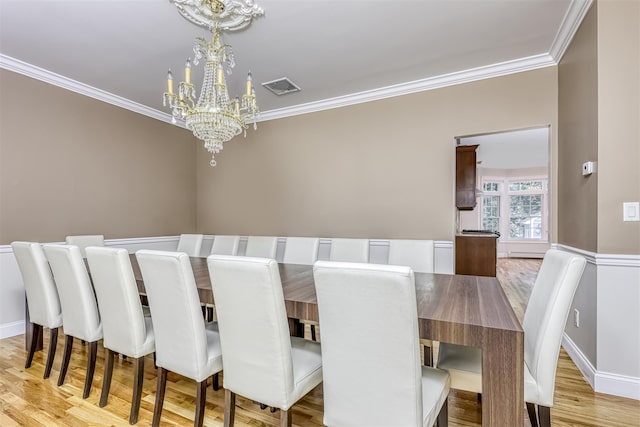 unfurnished dining area with a notable chandelier, visible vents, and ornamental molding