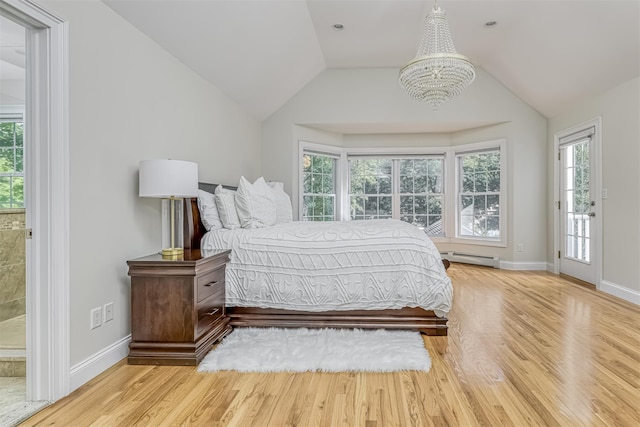 bedroom with baseboards, vaulted ceiling, an inviting chandelier, and wood finished floors