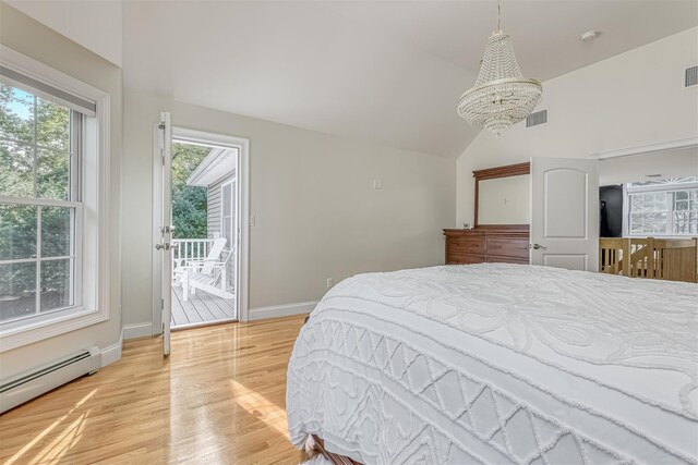 bedroom featuring vaulted ceiling, an inviting chandelier, light wood-style flooring, visible vents, and a baseboard radiator