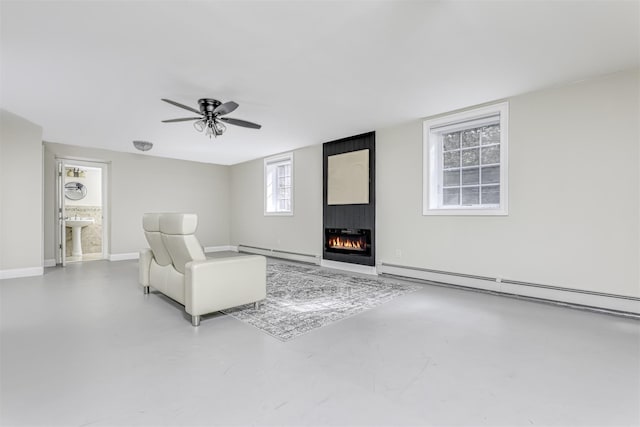 unfurnished living room with concrete flooring, a baseboard heating unit, a fireplace, and baseboard heating