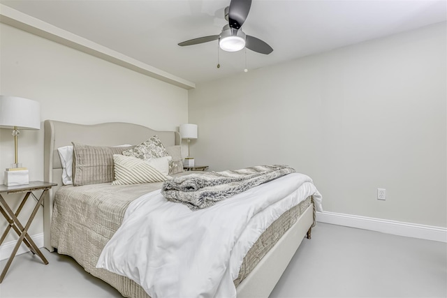 bedroom with finished concrete floors, ceiling fan, and baseboards