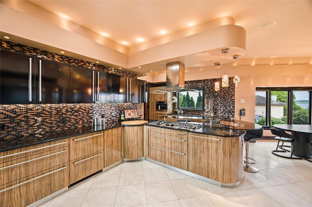 1101 Harbor Rd, Hewlett, NY 11557 - kitchen with a peninsula, light tile patterned floors, decorative backsplash, island range hood, and stainless steel gas stovetop