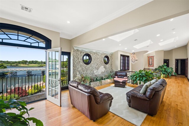 1101 Harbor Rd, Hewlett, NY 11557 - living room with visible vents, a water view, ornamental molding, wood finished floors, and a skylight
