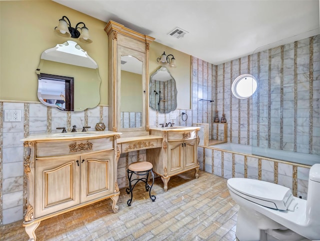 1101 Harbor Rd, Hewlett, NY 11557 - full bathroom featuring visible vents, tile walls, vanity, and tiled shower / bath combo