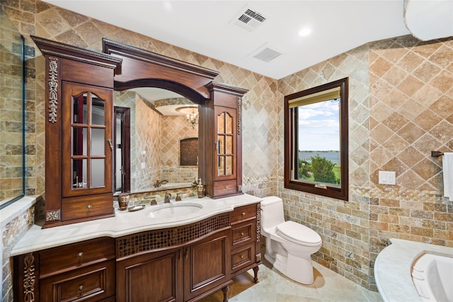 1101 Harbor Rd, Hewlett, NY 11557 - bathroom with toilet, vanity, visible vents, and tile walls