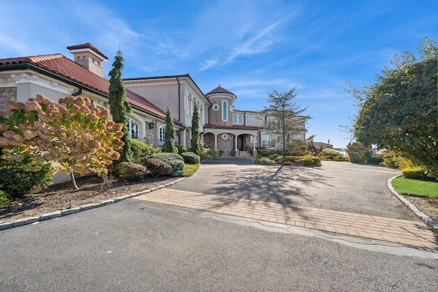 1101 Harbor Rd, Hewlett, NY 11557 - mediterranean / spanish house featuring a tiled roof and aphalt driveway