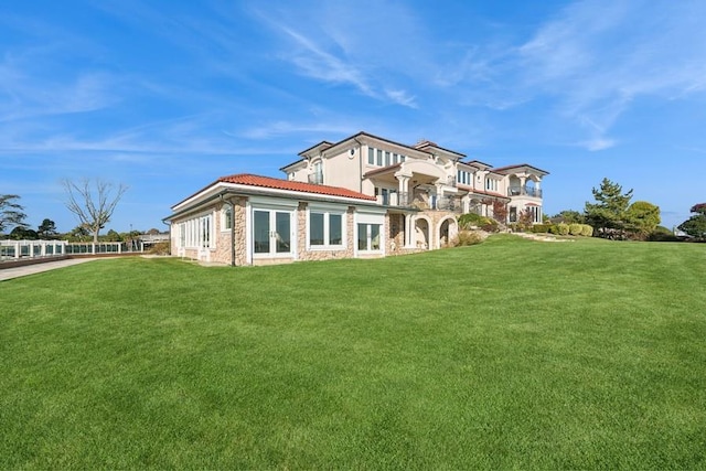 1101 Harbor Rd, Hewlett, NY 11557 - rear view of house featuring french doors, a lawn, and a tile roof