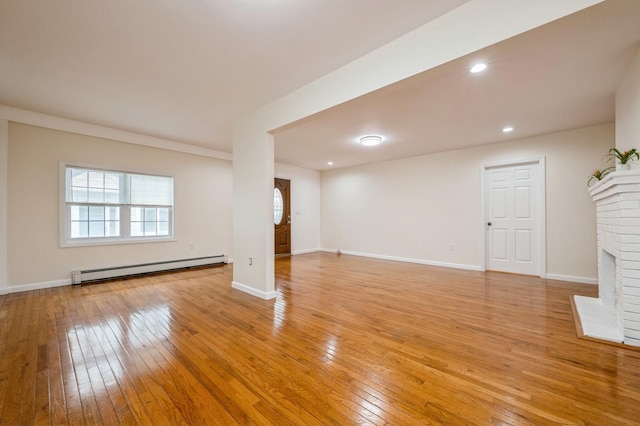 3 September Walk, Long Beach, NY 11561 - unfurnished living room featuring a baseboard radiator, light wood-type flooring, a brick fireplace, baseboards, and recessed lighting