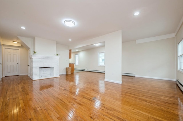 3 September Walk, Long Beach, NY 11561 - unfurnished living room with a baseboard heating unit, light wood-style flooring, a fireplace, recessed lighting, and baseboards