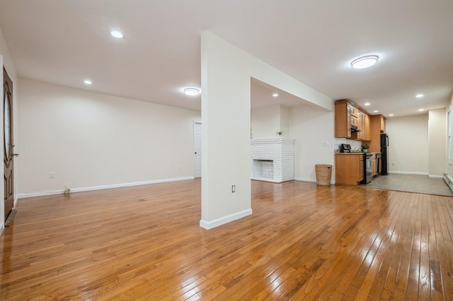 3 September Walk, Long Beach, NY 11561 - unfurnished living room with light wood-style flooring, a brick fireplace, baseboards, and recessed lighting
