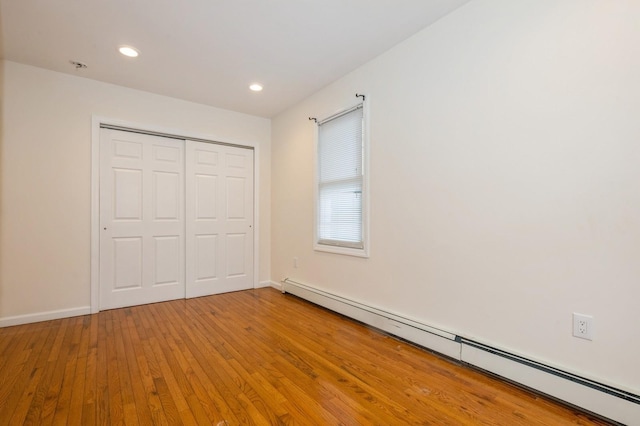 3 September Walk, Long Beach, NY 11561 - unfurnished bedroom featuring baseboard heating, light wood-type flooring, a closet, recessed lighting, and baseboards