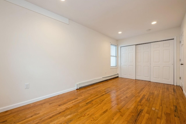 3 September Walk, Long Beach, NY 11561 - unfurnished bedroom featuring a baseboard radiator, wood finished floors, recessed lighting, baseboards, and a closet