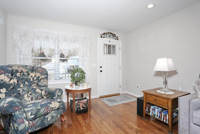 living area with wood finished floors, baseboards, and recessed lighting