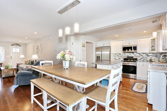 dining room with light wood-style flooring and visible vents