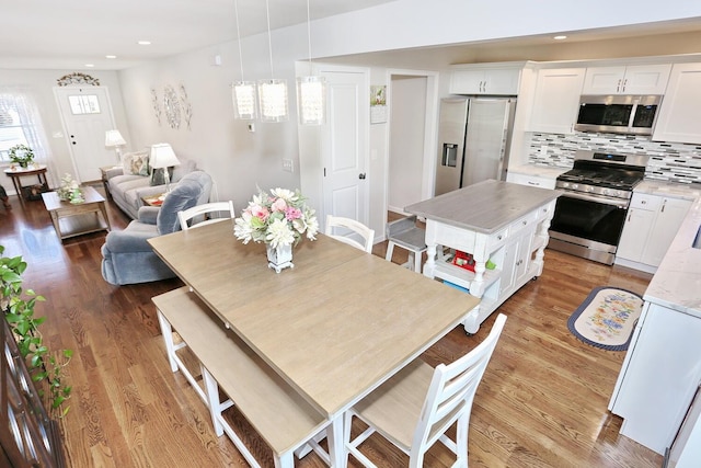 dining room with recessed lighting and light wood-style floors